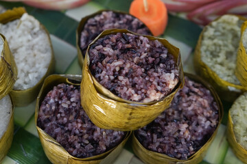 view of traditional food called Black sticky rice wrapped in banana leaves