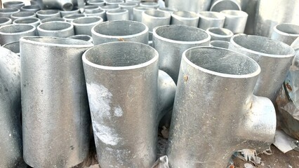 Naklejka premium Galvanized T joint pipe. Galvanization is the process of applying a protective zinc coating to steel or iron,to prevent rusting, Copper pipe on white with connector, Copper plumbing pipe leaking water