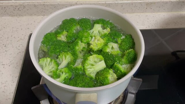 Fresh green broccoli cooked boiled in a pot. Healthy food and vegetables.