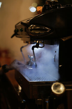 Coffee machine in a steam at cafe