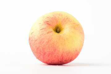 Fresh ripe apple with tiny water drops on white background