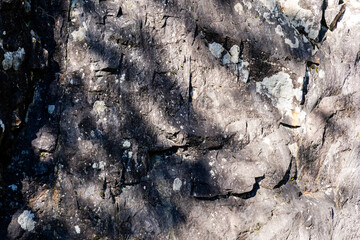 rough mountain cliff rock stone surface texture or background close-up