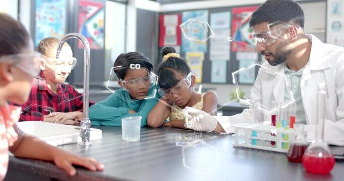 Chemistry teacher explaining molecular structures over children in science classroom