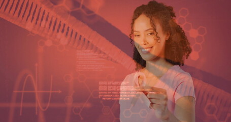 Image of dna strand and data processing over african american woman holding pink ribbon