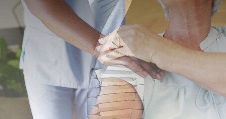 Image of dna strand over african american female doctor and senior caucasian woman