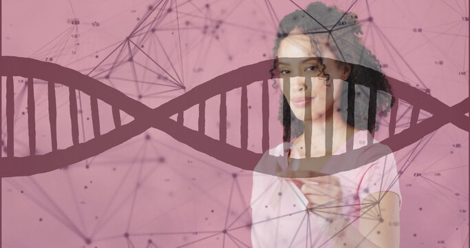 Image of dna strand and data processing over african american woman holding pink ribbon - Powered by Adobe