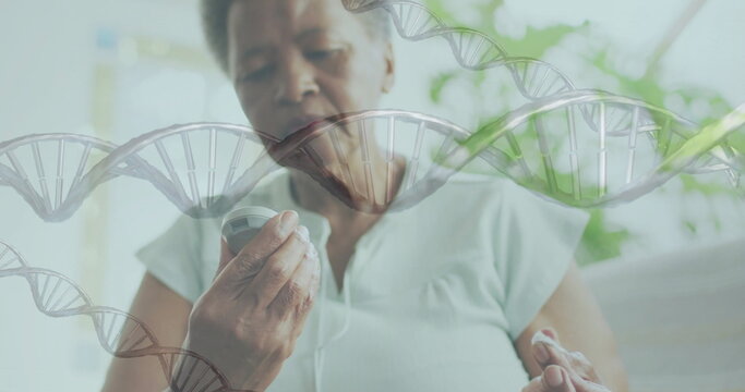 Image of dna strands over senior african american woman using glucose meter