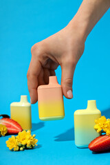 Electronic cigarettes in hand on a blue background