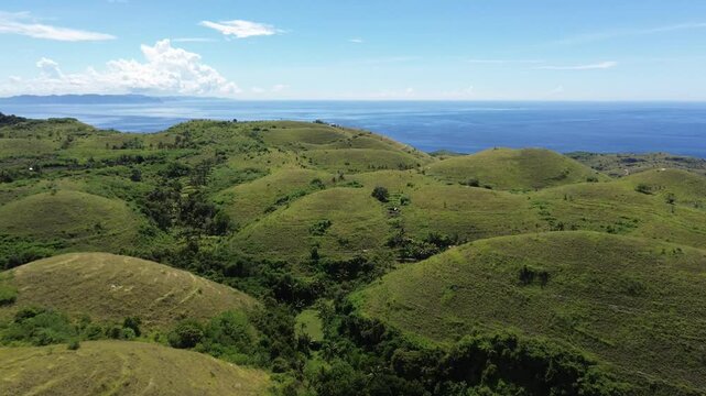 Teletubbies Hill with green rolling hills under a clear sky, Indonesia