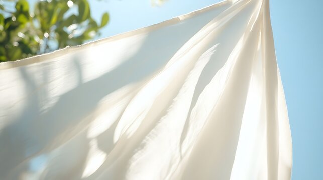White cotton sheets hanging in the sun, blowing gently in the breeze, evoking nostalgia and simplicity