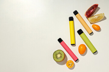 Electronic cigarettes with fresh fruit on a white background