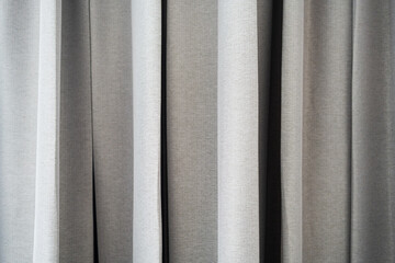 Fototapeta premium Brightly lit grey curtains decoration on window in home