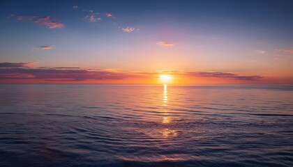 Obraz premium new beginning concept Beautiful orange sunset over the ocean. Reflected on the calm waters with a few clouds in the sky.
