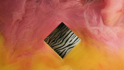 Mystic fog. Paint water. Pastel pink yellow color swirling smoke mixing around shiny geometric...