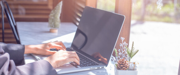 Woman working on laptop computer in office.For web banner.