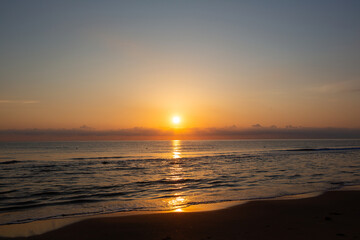 Stunning sunset at sea, bright colors reflecting on water.