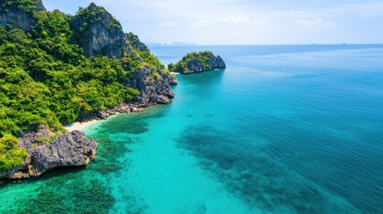 Fototapeta premium Stunning coastal view featuring clear turquoise waters, lush greenery, and rocky shores under a bright blue sky.