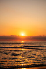Stunning sunset at sea, bright colors reflecting on water.