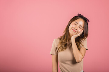 Portrait happy woman smiling resting appearance hands arms cheeks. Asian female wearing sunglasses and a brown shirt studio shot isolated on pink background, overjoyed affectionate emotions feelings