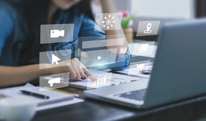 Digital marketing concept with businesswoman using computer laptop creating online adverts to increase sales. Using social media and websites for traffic and awareness, working in a modern office.