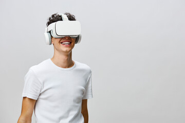 Virtual reality experience, smiling young man with VR headset, modern technology background, youthful and cheerful atmosphere, engaging in immersive activities