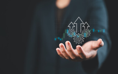 Process to increase productivity concept. Businessman holding productivity icon with growth graph for industrial management in efficiency and efficient process. Lean cost and productivity growth.