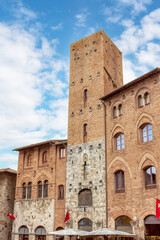The historic charm of Piazza Duomo in San Gimignano, Tuscany, with its stunning medieval architecture and beautiful sky