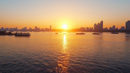 Obraz premium Golden Sunset Over City Skyline with Boats on Calm Water