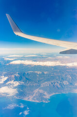 View from the airplane window of the mountains and sea resort with corals in Egypt, Sharm El Sheikh.Flight