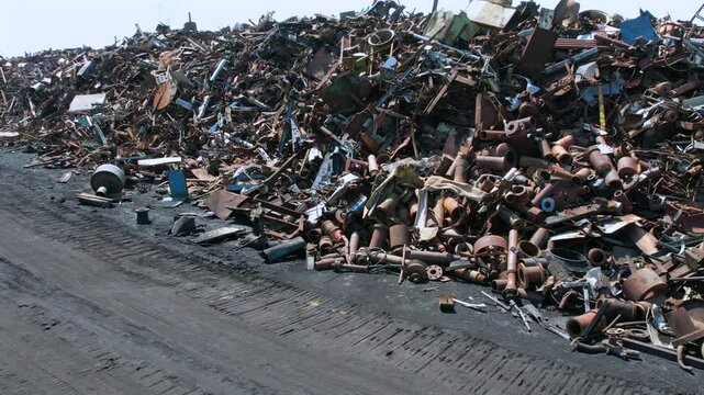 a mountain of scrap metal in an open-air industrial warehouse
