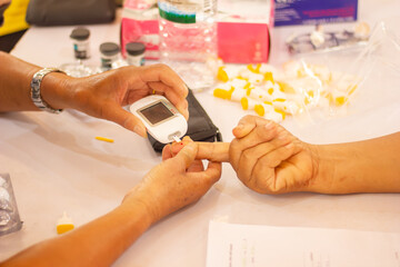 hand of people check diabetes and high blood glucose monitor with  glucosmeter