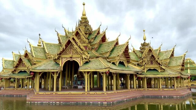 4K video footage of Pavilion of the Enlightened, a green temple complex in Muang boran Ancient city, Samut Prakan, Bangkok, Thailand. Famous green and gold roof structure, surrounded by a lake.