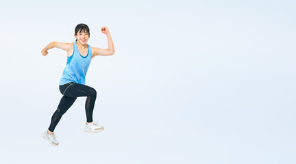 スポーツウェアを着てジャンプする女の子の全身写真（切り抜き背景透過PNGも販売しております。作成者リンクから「PNG」で検索してください）