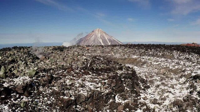 Frozen lava in the crater of the Avachinsky volcano, against the backdrop of the Koryaksky volcano, bird's eye view