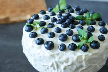 Cake with protein cream decorated with blueberries.