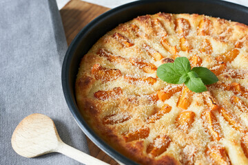 Homemade apricot pie with mint leaves.
