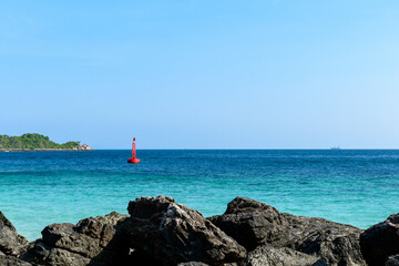 Landscape of blue sea and rocks on clear blue sky and island background morning day at Koh Larn island. Panorama ocean. Pattaya, Thailand. Wave, Fairway Buoy, Seascape.