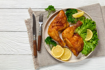fried chicken legs with lettuce, lemon on plate