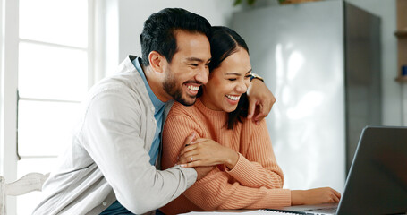 Home, couple and hug with laptop for finance, track expenses and success for budget goals. Discussion, man and woman with tax review for checking, handle savings and mortgage document in kitchen