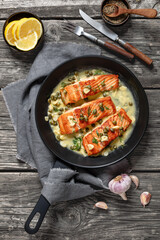 salmon piccata with lemon caper sauce in a pan