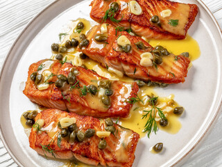 salmon piccata with lemon caper sauce on plate