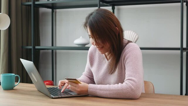 Asian businesswoman raised hands up she excited and happy amazed read good news from laptop computer at office, woman positive excited crazy smiling cheerful she fist say Yes!
