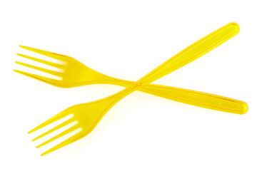 Two disposable yellow plastic fork isolated on white background. Close-up. Full depth of field.