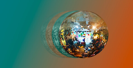 Party disco mirror ball reflecting orange and green lights