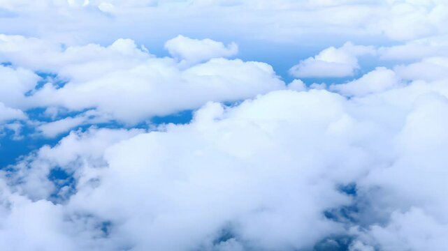 Top view from above, flat lay establishing scene: flat lay rotating cloud background with fluffy white cumulus clouds covering the entire frame space