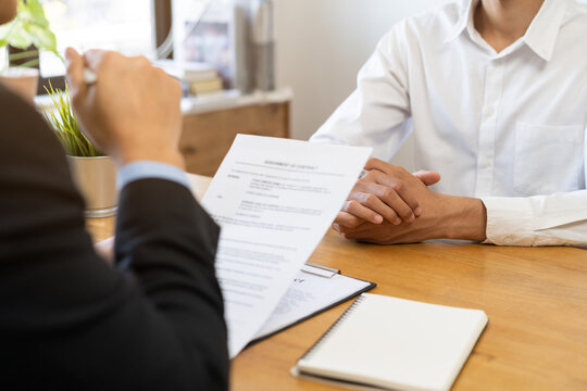 Asian young manager, employer man interview with person, have question about resume and listen to candidate answer, conversation together at office. Recruitment employee job concept.