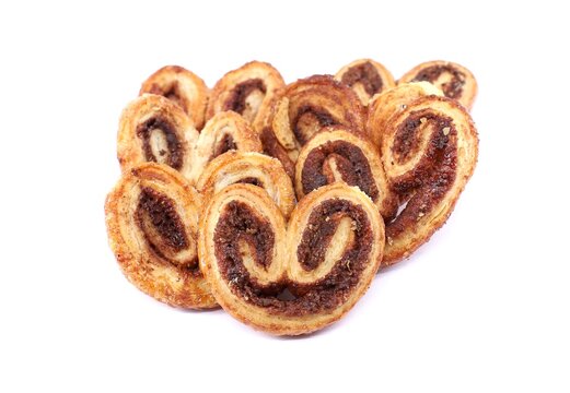 Prussien with cinnamon, known also as Palmier or Palmerita, on white background. It is a puff pastry cookie with pig's ear or palm heart shape spread all over Europe.