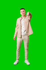 Young Man Making Disapproving Gesture Against Bright Green Background