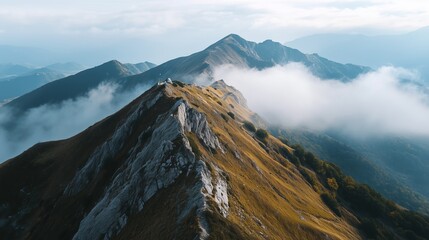 Beautiful mountain ridge with clouds and peaks around.