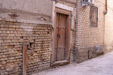 A brick wall with a door in front of it